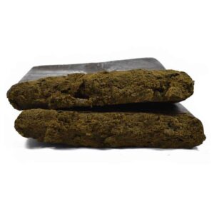 Two blocks of textured brown hashish on a white background.